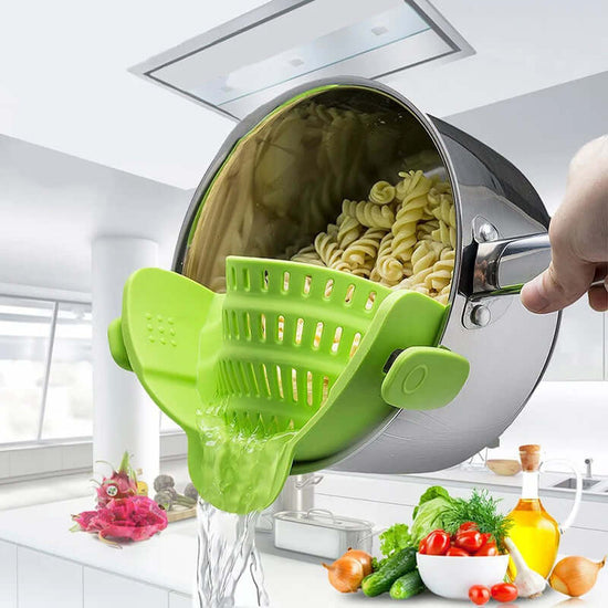 Clip On Silicone Pot Strainer draining pasta in a pot, demonstrating one-handed use and zero-mess functionality.