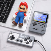 Retro Mini Handheld Game Console with controller and retro figure on a laptop