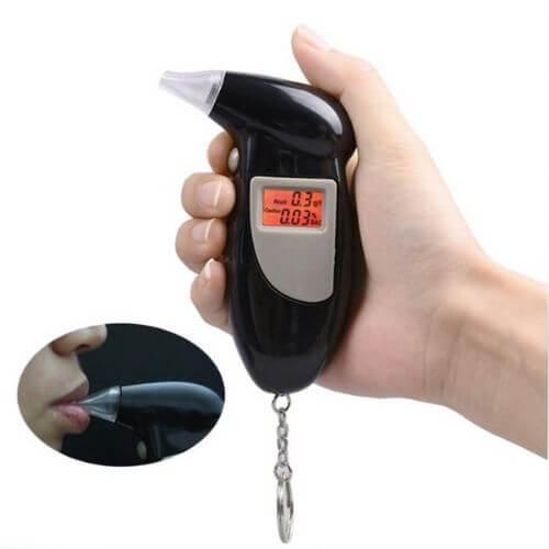 Portable Breath Alcohol Tester showing digital display in hand with keychain attachment.