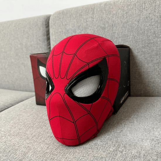 Animatronic Spider Mask on a sofa, featuring realistic blinking and winking eyes. Perfect for costume events and hero role-play.