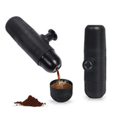 Portable Manual Espresso Maker brewing coffee, compact design, ideal for travel with up to 20 bars of pressure, black color.