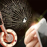 Close-up of 100 Languages I Love You Necklace projecting words with a smartphone light