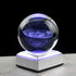 3D Crystal Galaxy Ball illuminating with a cosmic design on a lit base, perfect for decorative desk display or gifting.