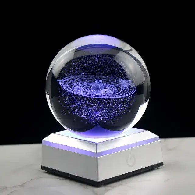 3D Crystal Galaxy Ball illuminating with a cosmic design on a lit base, perfect for decorative desk display or gifting.