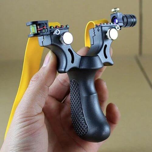 Hand holding a Laser Guided Slingshot with precision laser sight features.