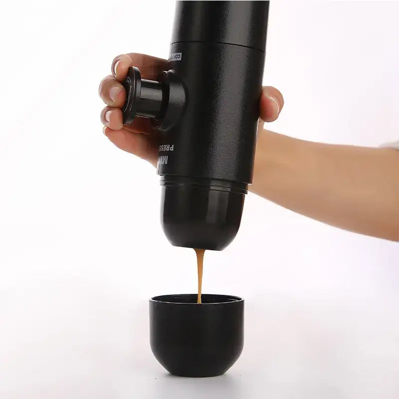 Using the Portable Manual Espresso Maker to brew espresso into a cup