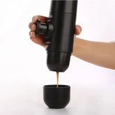 Using the Portable Manual Espresso Maker to brew espresso into a cup