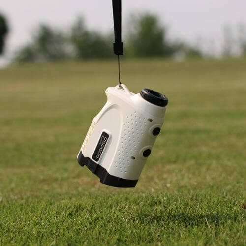 Rangefinder Golf device hanging on a strap, ideal for locking in distance on the golf course.