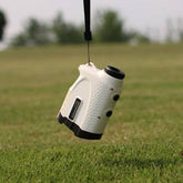 Rangefinder Golf device hanging on a strap, ideal for locking in distance on the golf course.