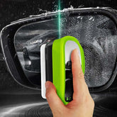 Using the Green Oil Film Wipe to clean a car mirror for crystal clear glass in seconds.