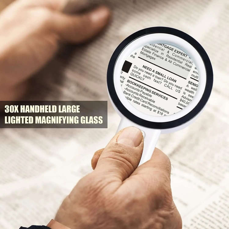Person using a 30X LED Magnifying Glass to read fine print on a newspaper.