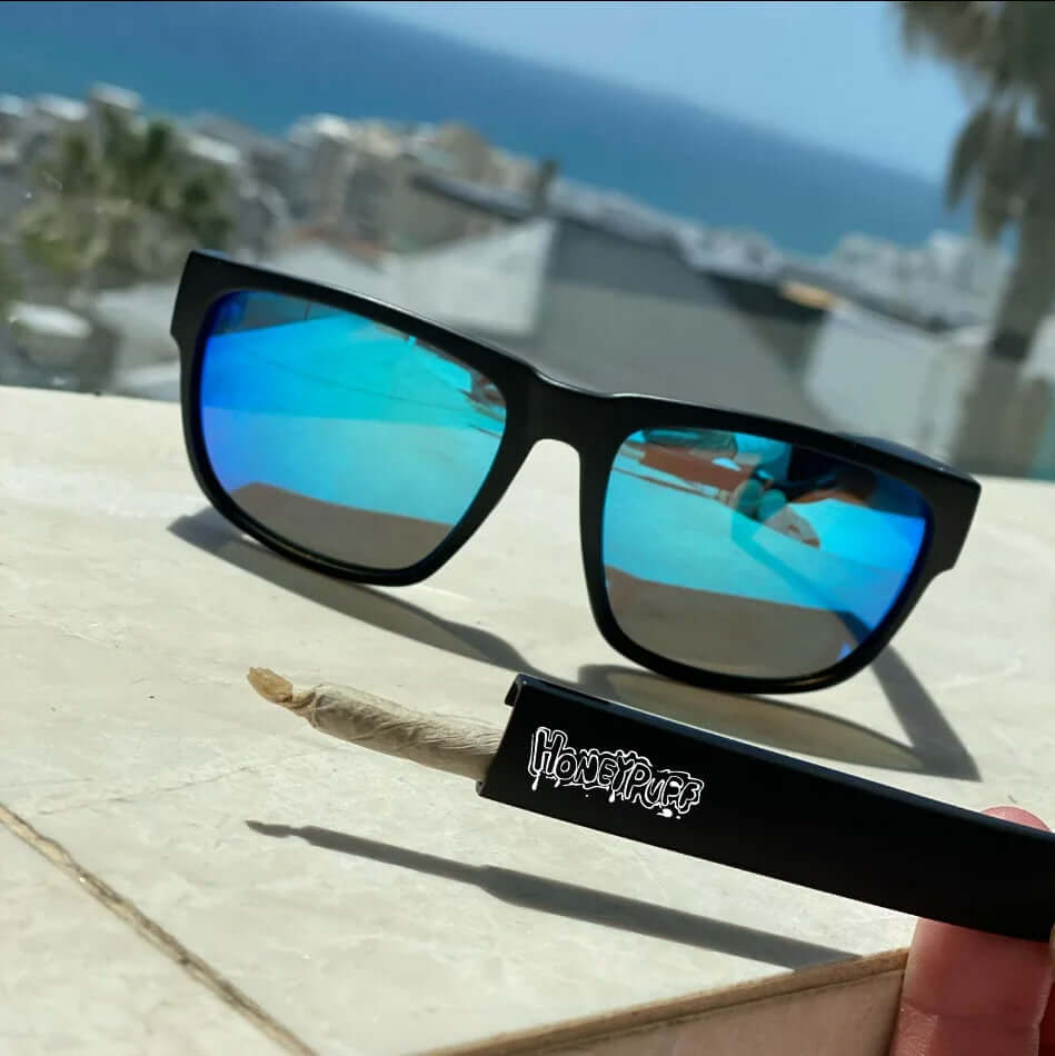 Stylish Hidden Storage Sunglasses with reflective blue lenses on a sunny balcony, showcasing discreet storage feature.
