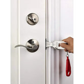 Installation of the Smart Portable Door Guard being demonstrated on a door for enhanced security.