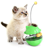 Kitten playing with green Interactive Cat Treat Ball for fun and snacks