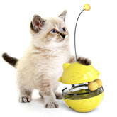 Cute kitten playing with Interactive Cat Treat Ball, a yellow toy for playtime and snacking fun.
