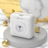 PeriPage Pocket Printer - inkless mini thermal printer on marble surface with golden decorations